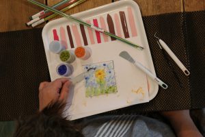 Person making fused glass piece at Fused Glass Workshop